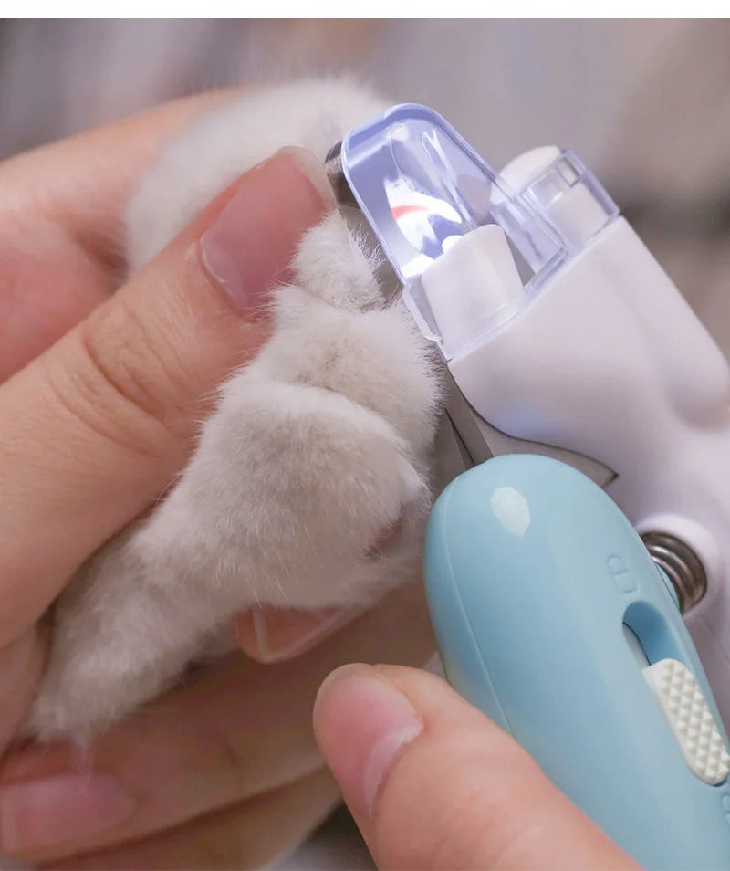 Pet nail clippers with LED light for dogs and cats, featuring ergonomic handle and safety guard for precise trimming of small pet claws.