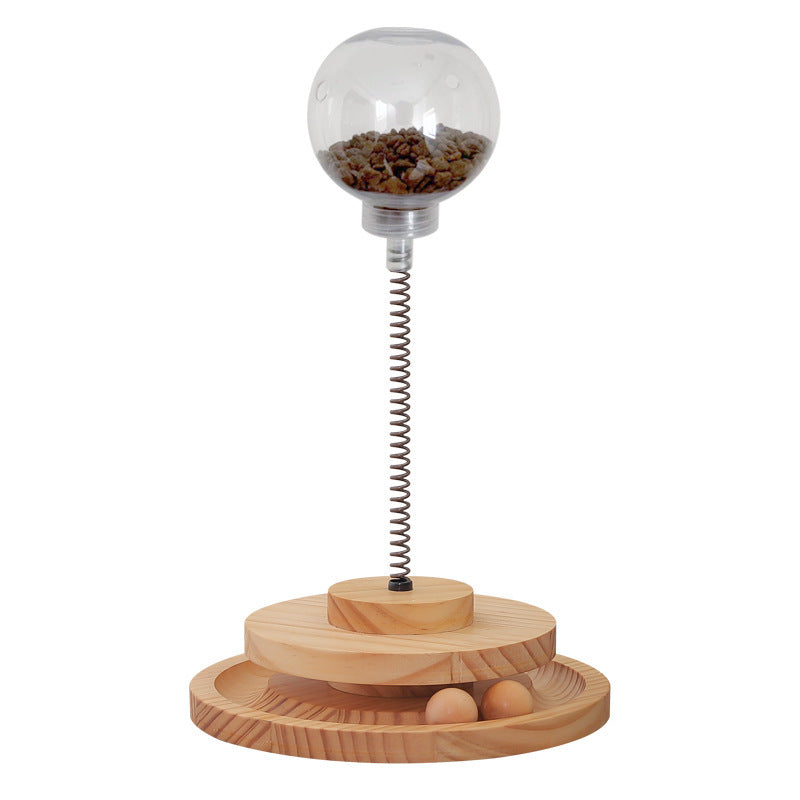 Cat Treats Dispenser Toy with spring-mounted clear ball filled with treats, wooden base, and interactive design for cats and small dogs.