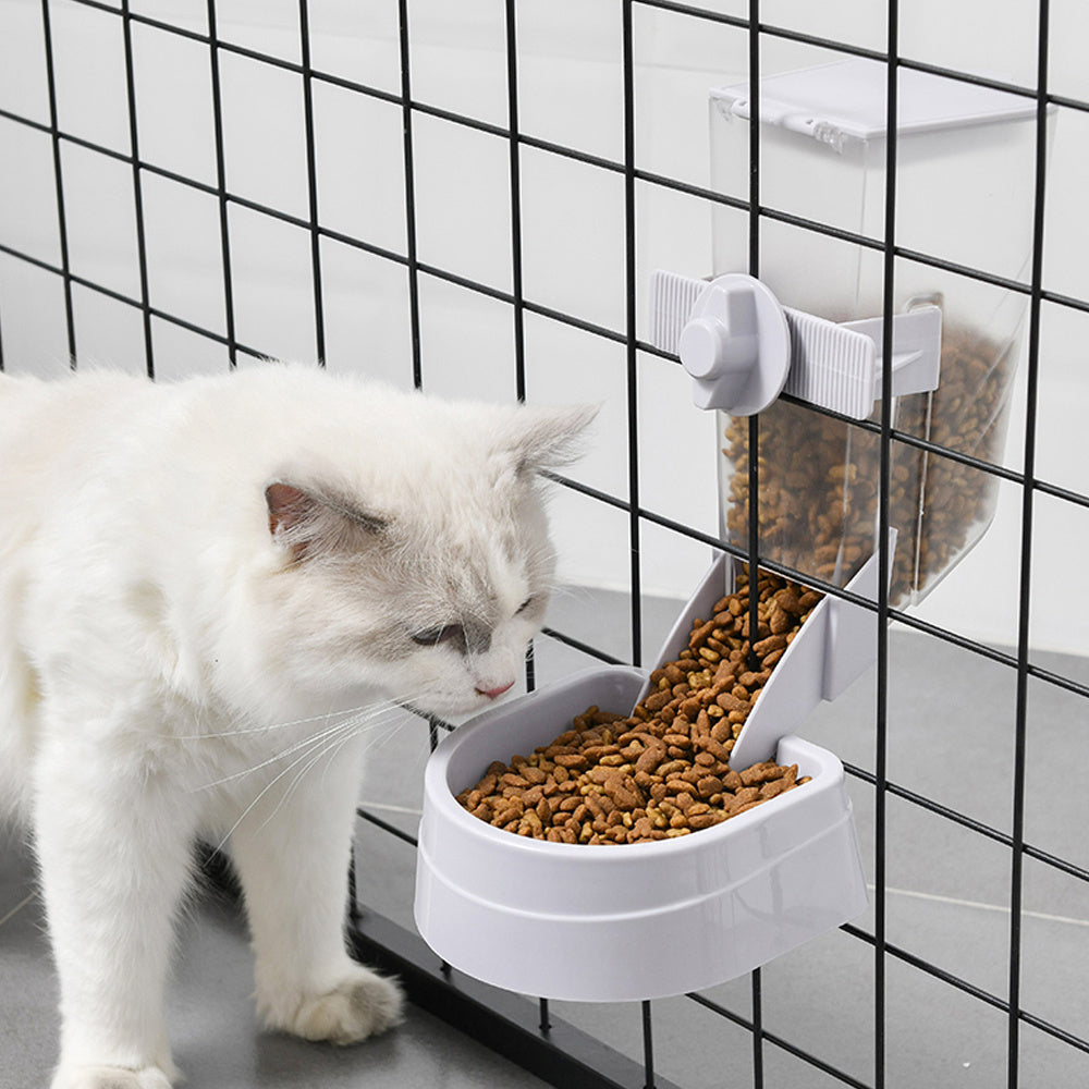 Blue suspended automatic feeder for cats and dogs mounted on a cage, featuring a transparent 2L container and bottom food tray.