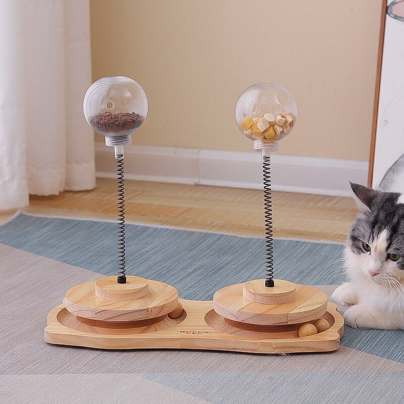 Cat Treats Dispenser Toy with spring-mounted clear ball filled with treats, wooden base, and interactive design for cats and small dogs.